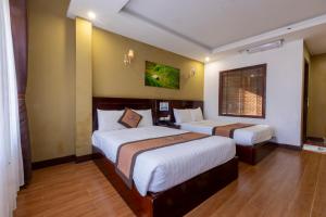 Ένα ή περισσότερα κρεβάτια σε δωμάτιο στο Sapa Melody Hotel