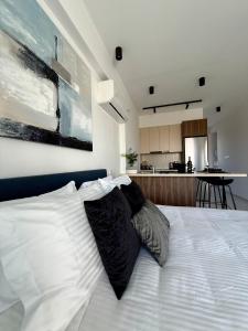 a bedroom with a bed with two pillows on it at Chill and Stay-Luxury Studio in Kato Paphos in Paphos City