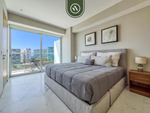 a bedroom with a large bed and a large window at Luxury 3 BR Condo - Beach Access 1 Block Away in Bucerías +53 photos