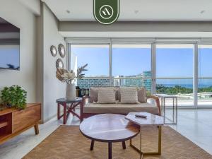 a living room with a couch and a table at Luxury 3 BR Condo - Beach Access 1 Block Away in Bucerías