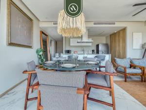 a dining room and kitchen with a table and chairs at Luxury 3 BR Condo - Beach Access 1 Block Away in Bucerías