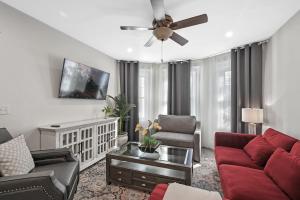 a living room with a couch and a ceiling fan at Roslindale village condos in Boston