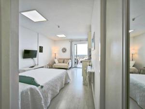 a hotel room with two beds and a living room at Girasol Rooftop View in Puerto de la Cruz +24 photos