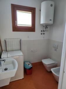 a bathroom with a sink and a toilet at Appartamento Torre Blu in Caorle