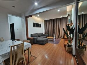 a living room with a couch and a table at Kuhara Homestay in Tawau +7 photos