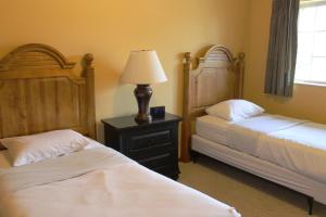a bedroom with two beds and a lamp on a night stand at 2 Bedroom Condo at Wild Eagle Lodge, #212 in Eagle River