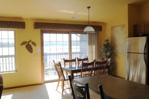 a kitchen and dining room with a table and a refrigerator at 2 Bedroom Condo at Wild Eagle Lodge, #212 in Eagle River