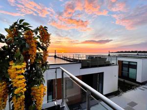 a view of the sunset from the balcony of a house at Floating Hideaway- Coco de Mer in Ribnitz-Damgarten