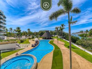 a view of the pool at the resort at Brand New 1 BR Condo - Pool - Jacuzzi - Gym in Nuevo Nayarit