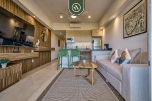a living room with a couch and a table at Brand New 1 BR Condo - Pool - Jacuzzi - Gym in Nuevo Nayarit