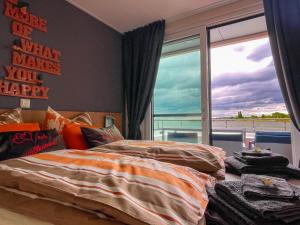 a bedroom with two beds and a large window at Floating Hideaway- Coco de Mer in Ribnitz-Damgarten