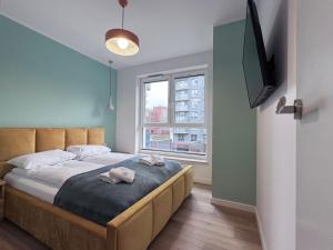 Łóżko lub łóżka w pokoju w obiekcie Apartamenty "Bastion Wałowa'' Q4Apartments