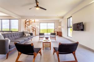 a living room with a couch and chairs at 8BDR Beach Private Chef -Wedding & Retreats /Golf Akumal CASA MILAH in Akumal