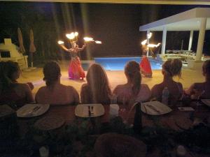 a group of people watching a woman performing on a stage at 8BDR Beach Private Chef -Wedding & Retreats /Golf Akumal CASA MILAH in Akumal +95 photos