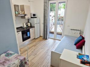a small apartment with a kitchen and a living room at Borgo and Bike in Finale Ligure