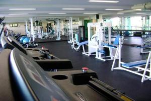 a gym with rows of treadmills and machines at Porto Real Resort - Apto 3 Suites - Por do Sol Genial in Mangaratiba