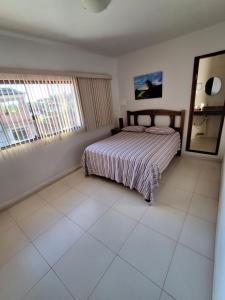 a bedroom with a bed and a mirror in it at Pousada Recanto do Japa in Nilo Peçanha