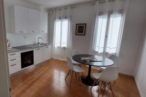 a kitchen with a table and chairs in a room at Casa Dimatore in Dolo