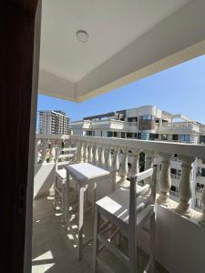 a balcony with tables and chairs on a building at Kheyre Nyali Ocean View Studio Apartments in Mombasa