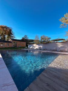 a swimming pool with blue water in a yard at Grange ALMA in Obernai +36 photos