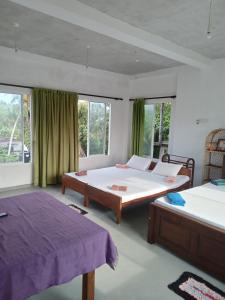 Ένα ή περισσότερα κρεβάτια σε δωμάτιο στο Mallika Resort