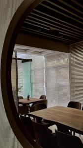 a room with tables and chairs and a mirror at Hotel Queen in Tirana