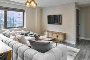 a living room with a couch and a tv at Host & Stay - Chic Townhouse by the Docks in Liverpool +9 photos