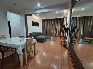 a living room with a table and a couch at Kuhara Homestay in Tawau