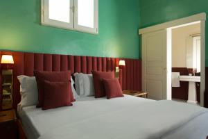 ガリポリにあるPalazzo Colomboの赤と緑の壁のベッドルーム1室(大型ベッド1台付)