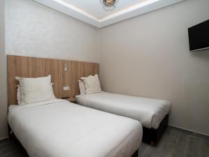 Voodi või voodid majutusasutuse HOTEL CAFE PALAIS SALAM , Beni Mellal toas