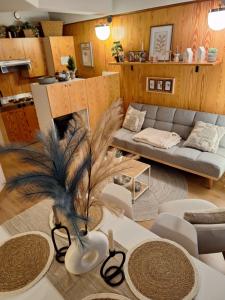 a living room with a couch and a table at Appartamenti Vacanze Casa -Residence Albare - check in Vacanze Casa - Marilleva 900 in Marilleva