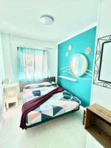 a bedroom with a bed and a mirror on the wall at Casa Canaria shared house in El Médano