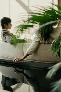 a man and a woman sitting on a couch at JW Marriott Hotel Istanbul Marmara Sea in Istanbul