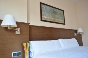 Postel nebo postele na pokoji v ubytování Hotel Palacio Congresos