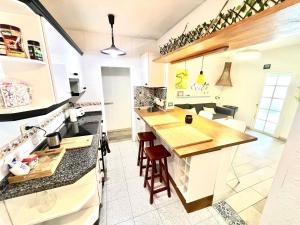 a kitchen with white cabinets and a counter top at Casa Canaria shared house in El Médano