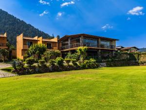 a house with a lawn in front of it at Hotel Campestre, Valle de Bravo in Valle de Bravo