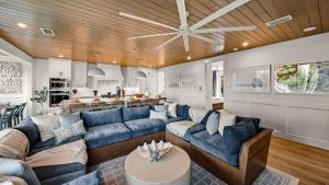 a living room with blue couches and a kitchen at Siesta Springs in Siesta Key