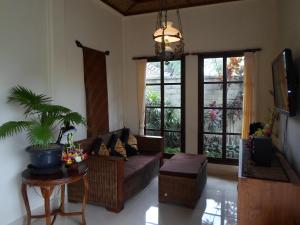 a living room with a couch and a table at Lily Lane Villas in Ubud