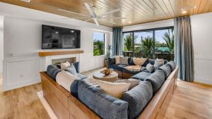 a living room with a large couch and a fireplace at Siesta Springs in Siesta Key