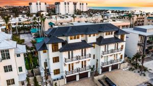 an aerial view of a white building with black roofs at Siesta Springs in Siesta Key