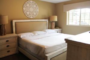 a bedroom with a large white bed and a window at 2 Bedroom Condo at Wild Eagle Lodge, #136 in Eagle River