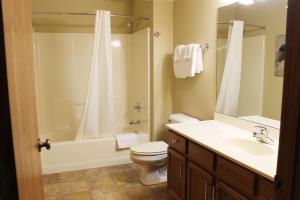 a bathroom with a toilet and a sink and a shower at 2 Bedroom Condo at Wild Eagle Lodge, #136 in Eagle River +26 photos
