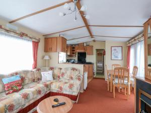 a living room with a couch and a table at 120 Caravan in Great Yarmouth