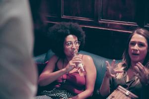 two women sitting on a couch drinking from a glass at Astor Hyde Park Hostel in London +37 photos