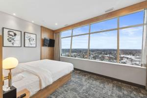 a bedroom with a bed and a large window at Tower Hotel at Fallsview in Niagara Falls