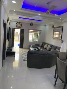 a large living room with a couch and a table at Paradise Estate in Katamanso +11 photos