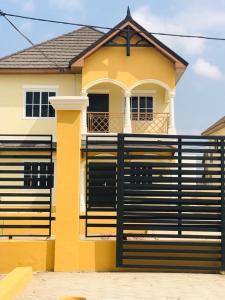 a house with a black fence in front of it at Paradise Estate in Katamanso