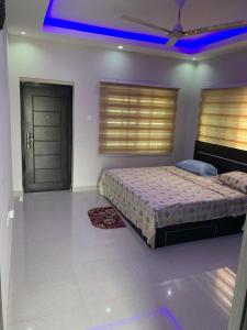 a bedroom with a bed and a blue light at Paradise Estate in Katamanso