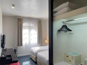 a hotel room with a bed and a window at 24 Inn at BTS Phrom Phong in Bangkok
