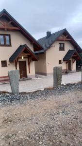 a house with a building with a porch at Agroturystyka u Doroty in Brenna